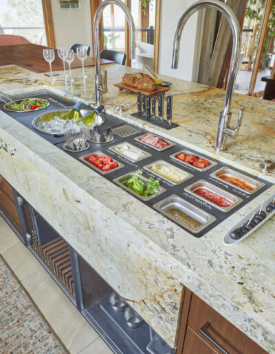 stone kitchen counter with buffet of food and wine